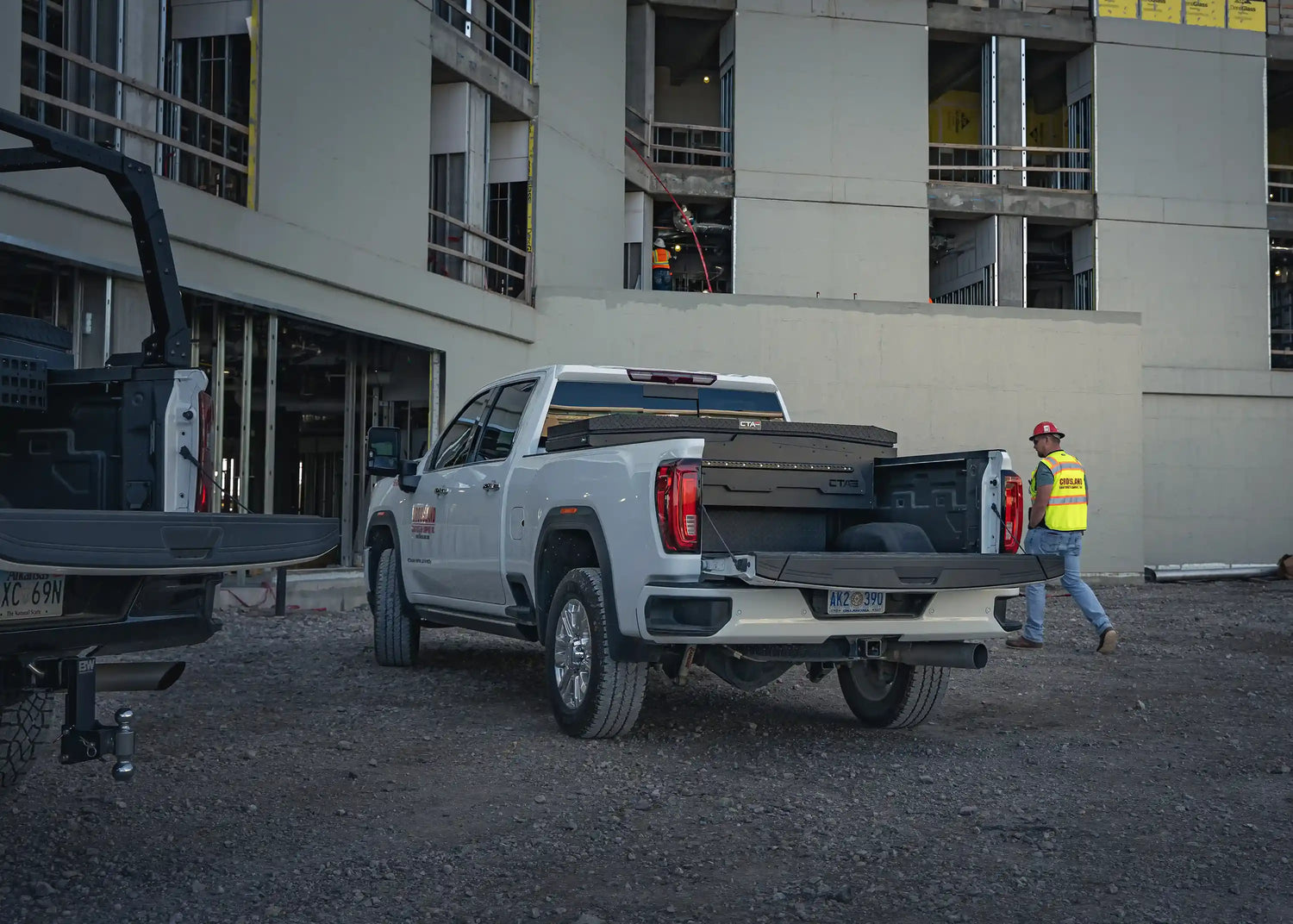 White pickup trucks on a construction site upgraded with tool boxes, ladder racks, bumpers, and other truck accessories at Starwood Custom Vehicles in Northwest Arkansas